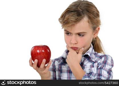 Little girl holding apple