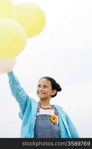 Little Girl Holding Balloons