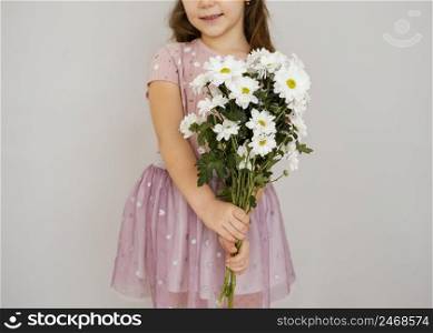 little girl holding bouquet spring flowers