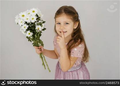 little girl holding bouquet spring flowers asking silence