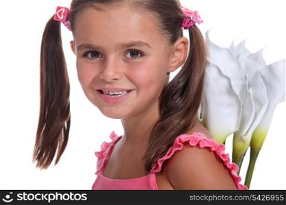 Little girl holding flowers behind back