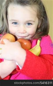 little girl holding fruit
