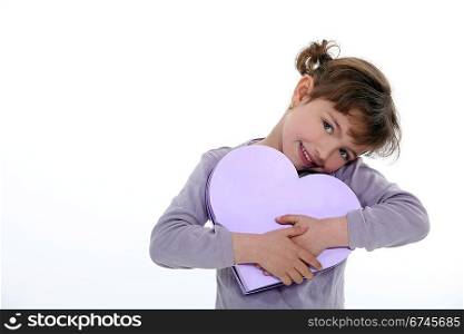 little girl holding gift bow shaped as a heart