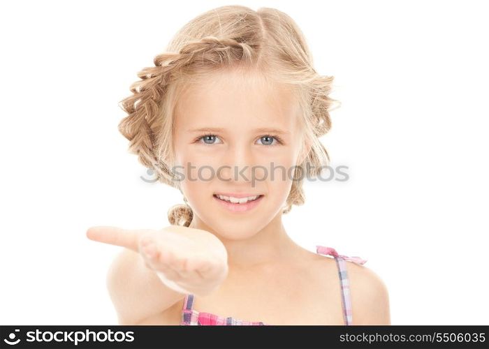 little girl holding something on the palm of her hand&#xA;