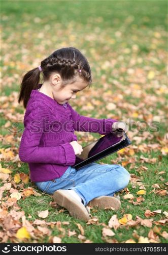 Little Girl holding tablet digital computer