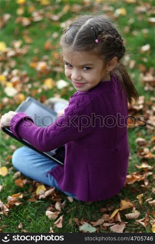 Little Girl holding tablet digital computer ??????? ???????? ??????? ? ??????? ?????
