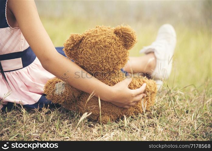little girl hugging a fluffy teddy bear