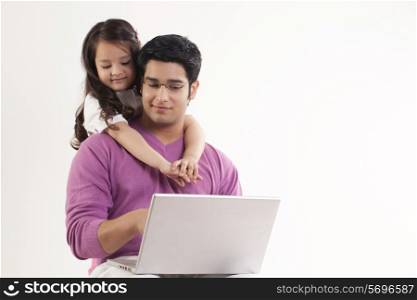 Little girl hugging her father over white background