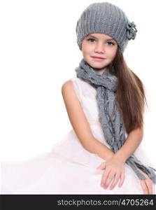 little girl in a knitted hat and gray scarf