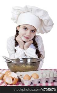 Little girl in a white apron breaks near the plate with eggs, isolated on white background