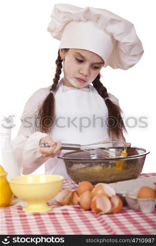 Little girl in a white apron breaks near the plate with eggs, isolated on white background