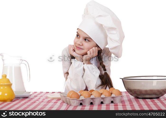 Little girl in a white apron near the box with eggs, isolated on white background