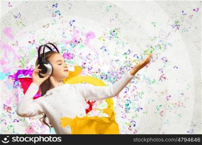 Little girl in headphones. Little cute girl in headphones enjoying music