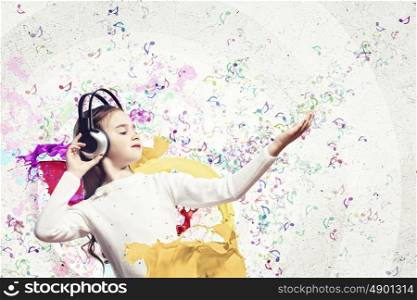 Little girl in headphones. Little cute girl in headphones enjoying music