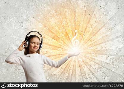 Little girl in headphones. Little girl in headphones with eyes closed enjoying music