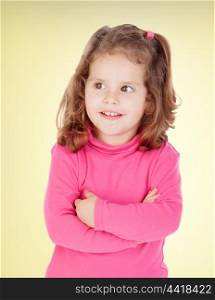 Little girl in pink with a yellow background