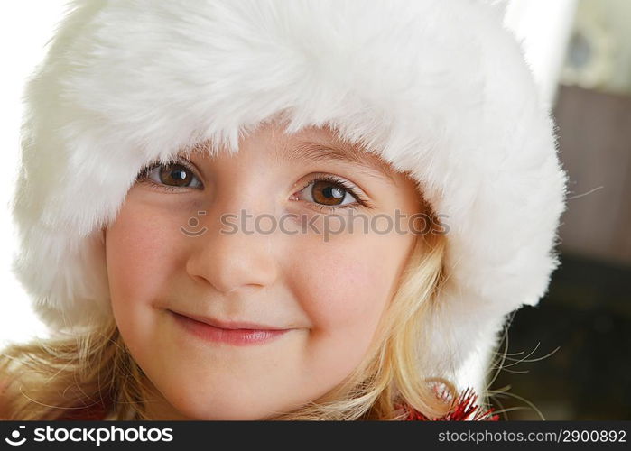 little girl in red santa hat on white background. portrait