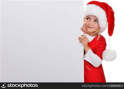 little girl in red santa hat peeking from billboard.