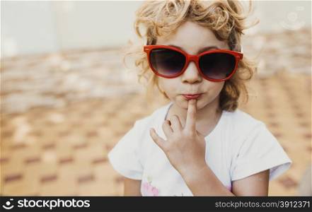 Little girl in red sunglasses, portrait