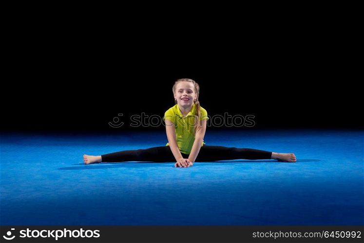 Little girl in sports hall isolated