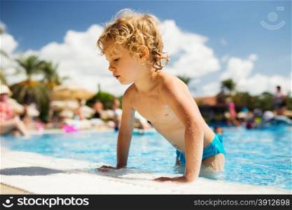 Little girl in swimming pool. Summer outdoor.