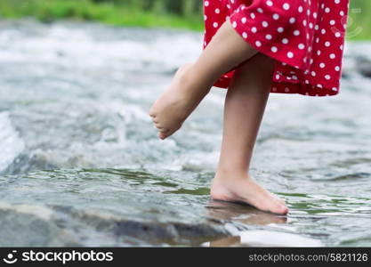 Little girl in the mountain brook