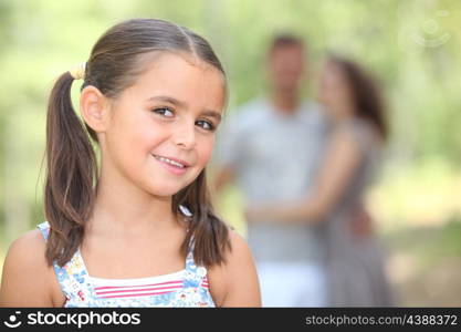 Little girl in the park with parents