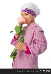 Little girl in traditional muslim clothes with rose flower isolated