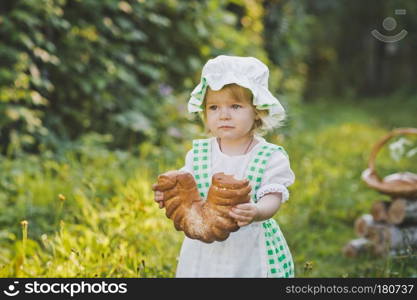 Little girl in vintage dress walking in the garden.. The child in the dress of a cook walking in the garden 4632.