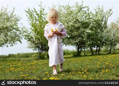 little girl in white clothes in spring park
