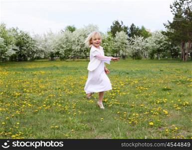little girl in white clothes in spring park