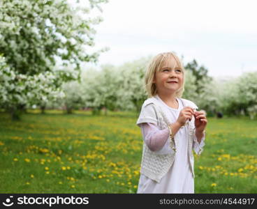 little girl in white clothes in spring park