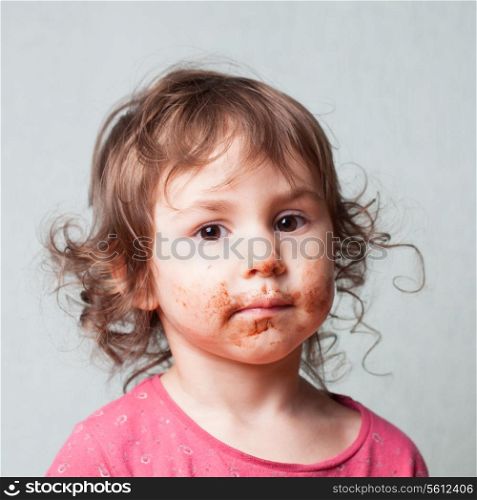 Little girl is dirty with chocolate. Funny face