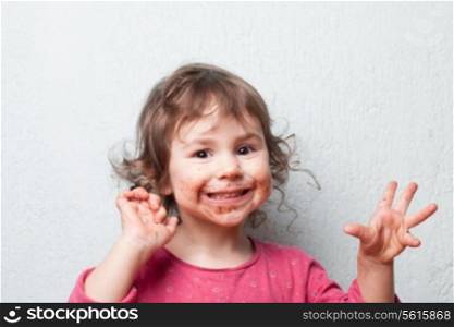 Little girl is dirty with chocolate. Funny face