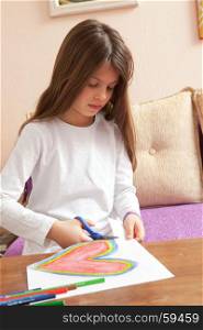 Little Girl is Drawing Red and Colorful Heart for Mothers Day or Fathers Day or Valentines Day. Birthday