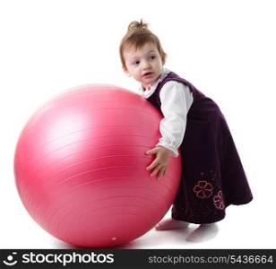 Little girl is playing with fitball isolated on white