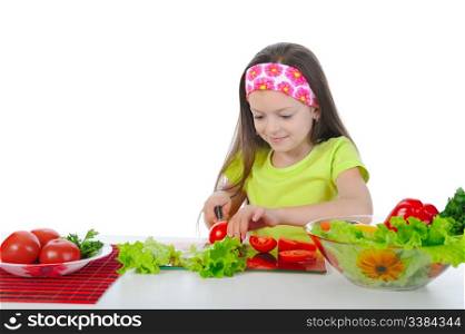 little girl is preparing salad at the table. Isolated on white background