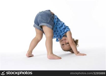 Little Girl Is Standing On Hands And Feet