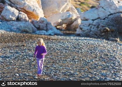 Little girl jumping on sea