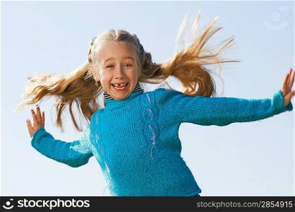 Little girl jumping outdoors