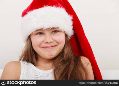 Little girl kid in santa claus hat. Christmas.. Cute little girl kid in red santa claus hat and white dress. Chrtistmas holiday season.