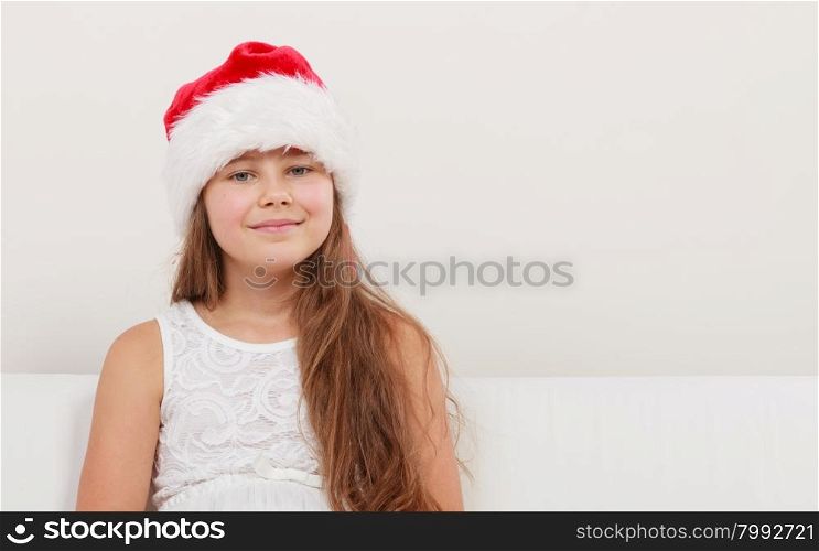 Little girl kid in santa claus hat. Christmas.. Cute little girl kid in red santa claus hat and white dress. Chrtistmas holiday season.