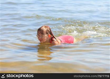Little girl kid swimming in sea water. Fun. Little girl child swimming in ocean. Kid and woman bathing in sea water. Summer vacation holiday relax.