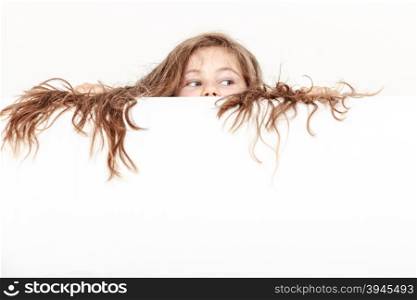 Little girl kid with long hair holds empty banner.. Little girl kid with long hair holding empty blank white banner for copyspace. Advertisement.