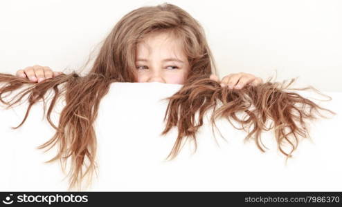 Little girl kid with long hair holds empty banner.. Little girl kid with long hair holding empty blank white banner for copyspace. Advertisement.