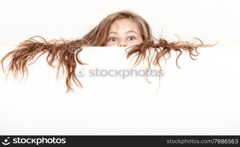 Little girl kid with long hair holds empty banner.. Little girl kid with long hair holding empty blank white banner for copyspace. Advertisement.