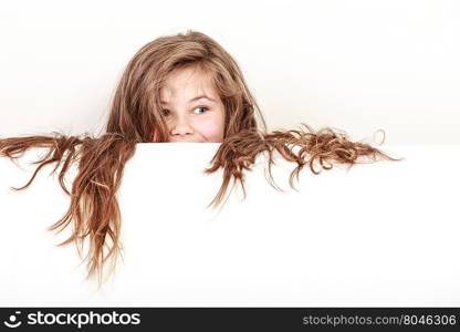 Little girl kid with long hair holds empty banner.. Little girl kid with long hair holding empty blank white banner for copyspace. Advertisement.