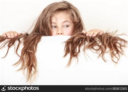 Little girl kid with long hair holds empty banner.. Little girl kid with long hair holding empty blank white banner for copyspace. Advertisement.