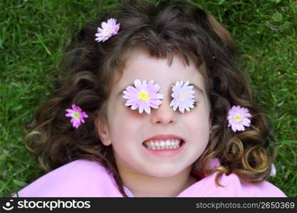little girl laying grass daisy flowers in eyes