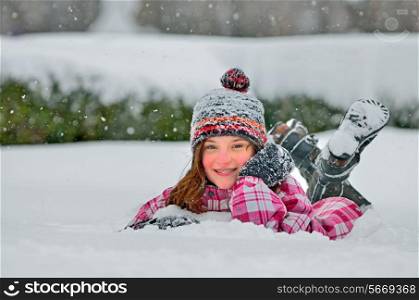 little girl laying on the snow